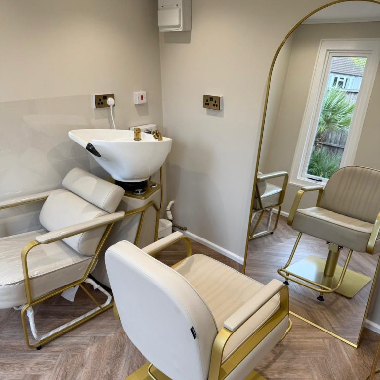 Blow Dry and Styling A person using a hairdryer and round brush on another person's hair.